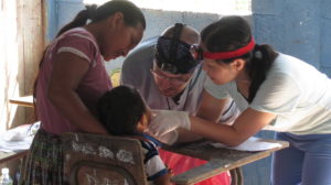 Dentists from St Francis Medical Mission team attend to village boy