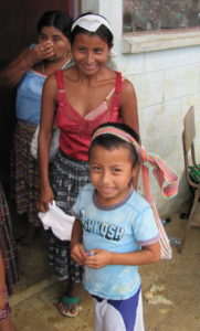 Village mother and son wait to receive medical attention from mission team